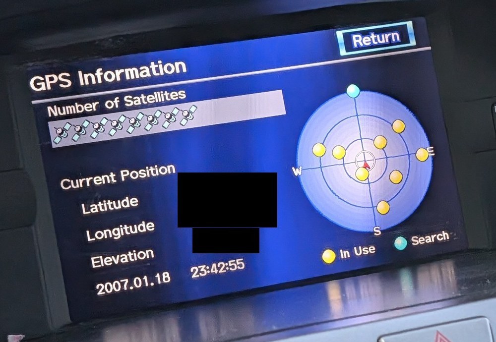 The GPS Information screen showing eight satellites in use, the time 23:42:55 and the date 2007.01.18. The latitude, longitude and elevation values are covered.